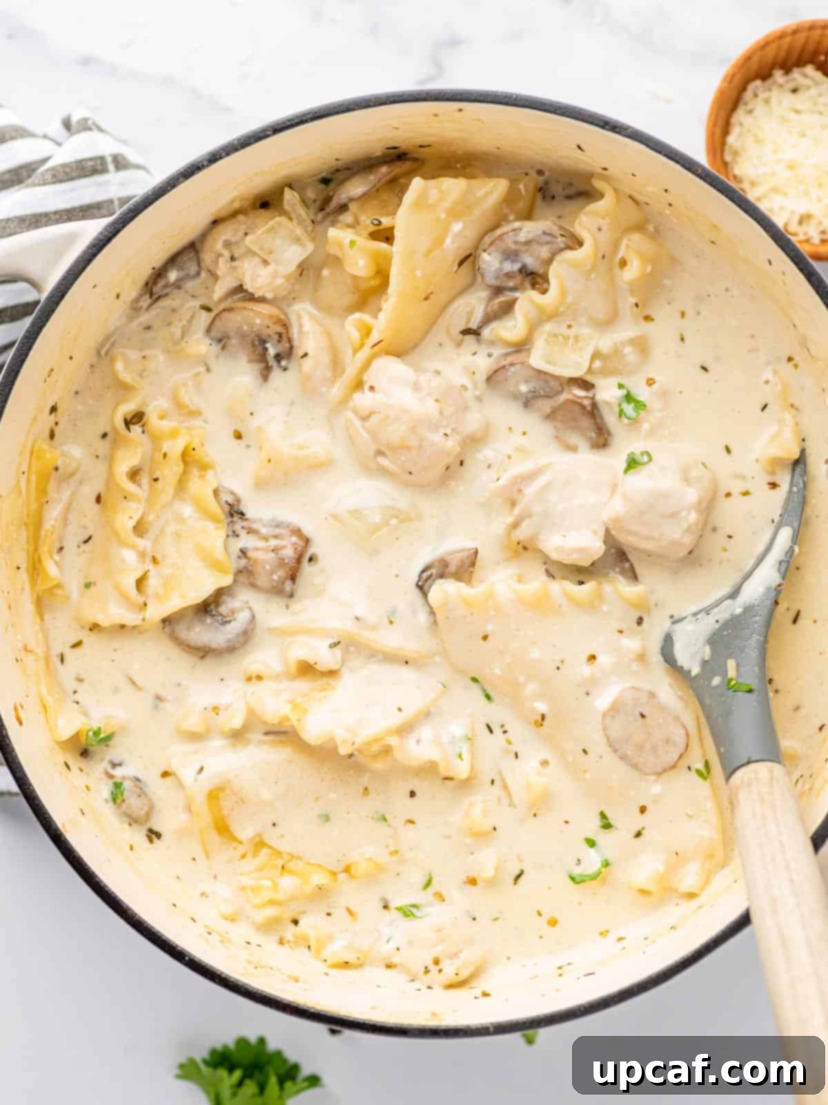 Creamy Chicken Lasagna Soup 9 One pot chicken lasagna soup served with a serving spoon, ready to be enjoyed.