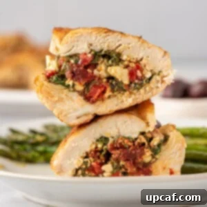 Sun-Drenched Mediterranean Stuffed Chicken 11 Two halves of a Mediterranean stuffed chicken breast stacked on top of each other.