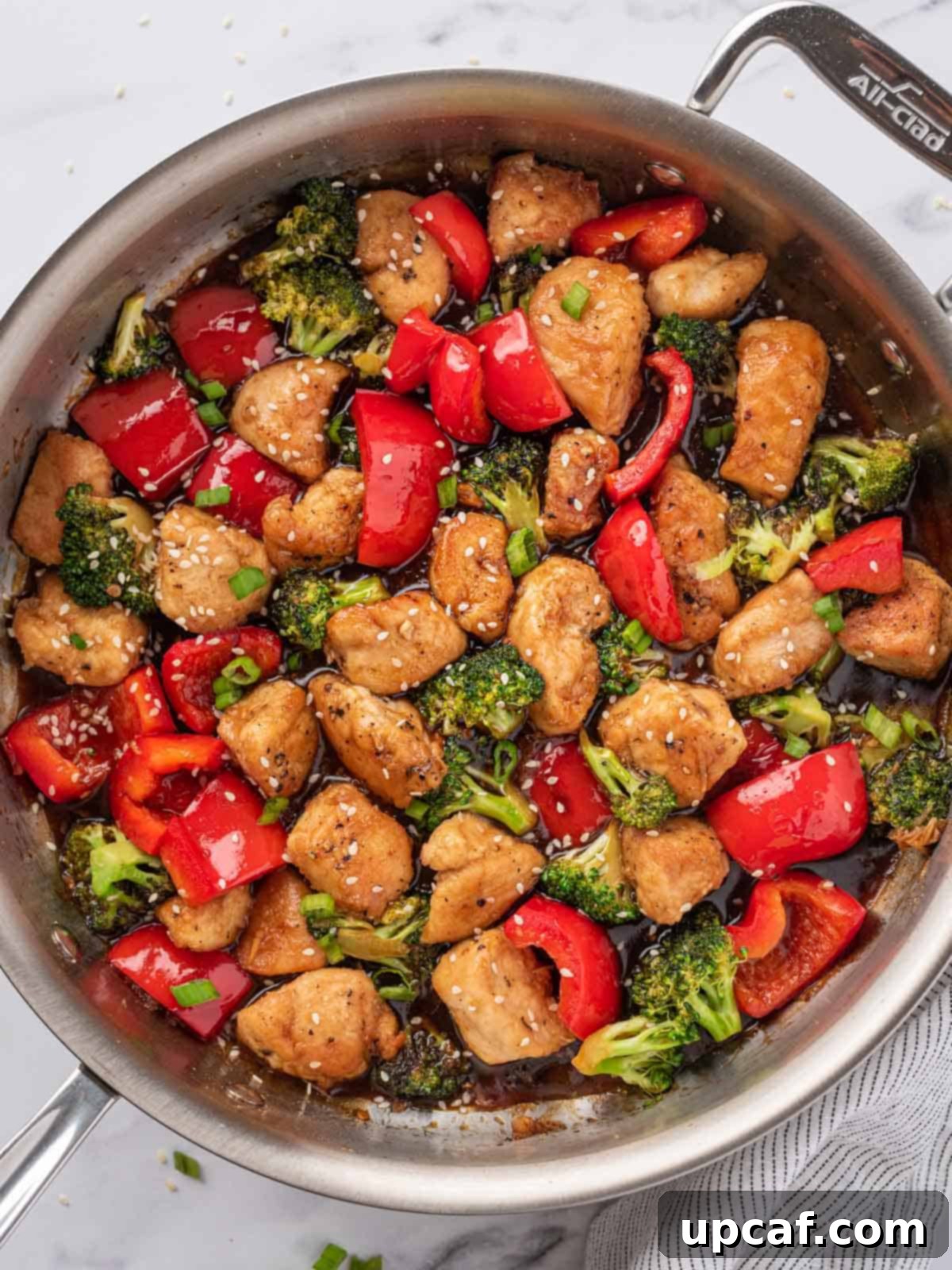 A finished skillet generously filled with vibrant chicken teriyaki stir fry, ready to be served.