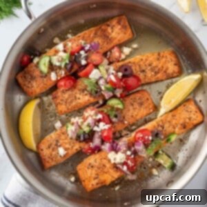 A skillet with grilled greek salmon and salsa.