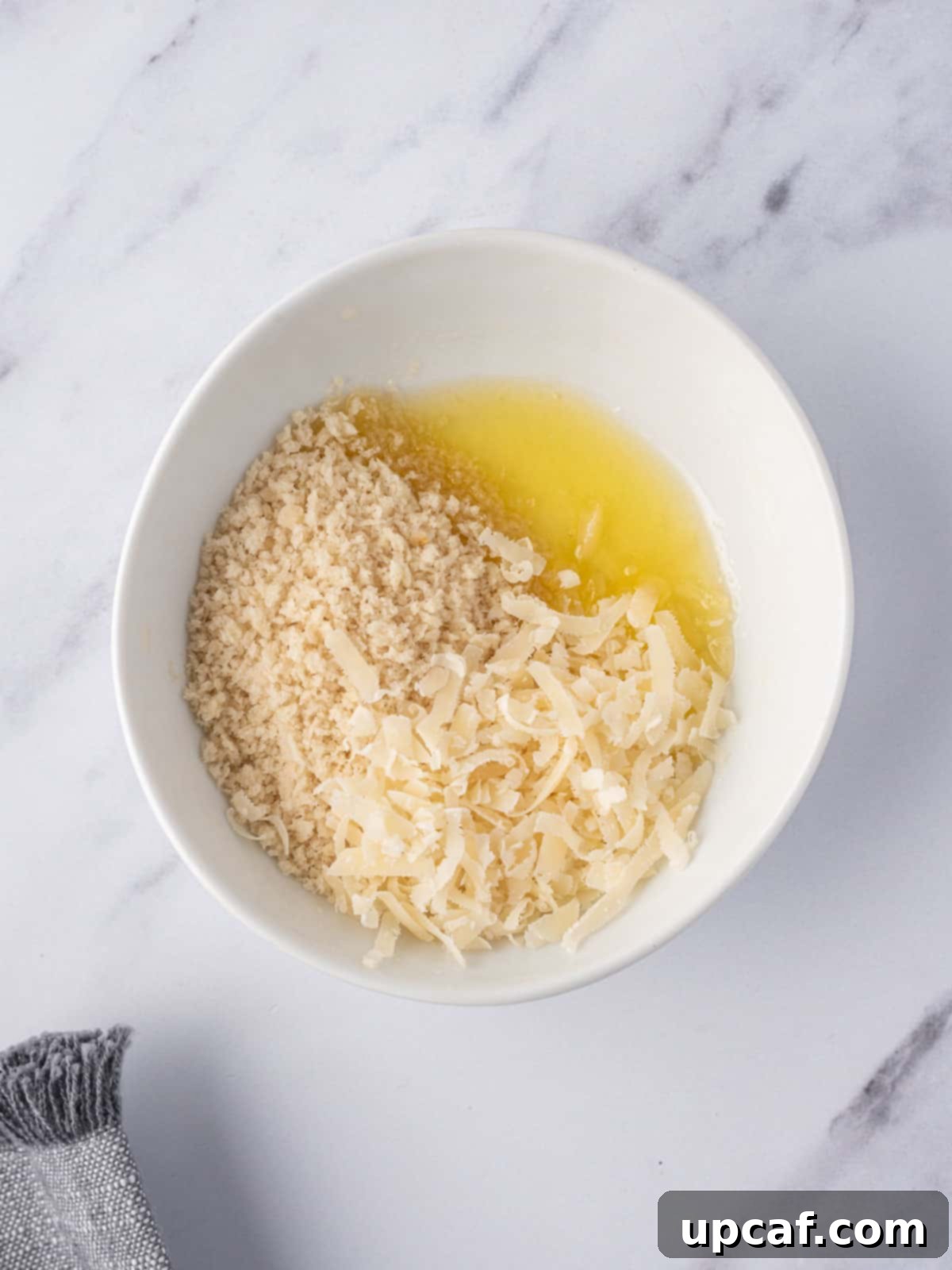 Cheesy Keto Cauliflower Bake 7 Mix of cheese bread crumbs and butter for crunchy topping.