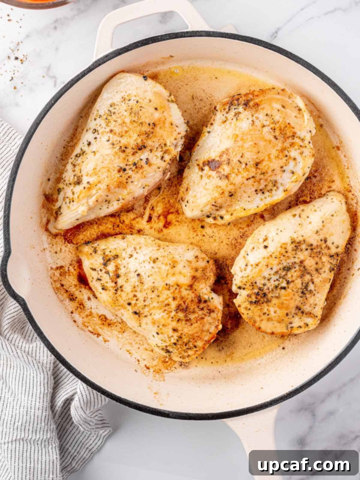 Keto Chicken Parm Skillet 5 Chicken breasts searing in a hot skillet, developing a golden crust.