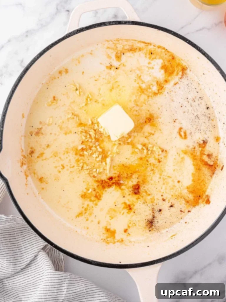 Butter and garlic added to a pan.