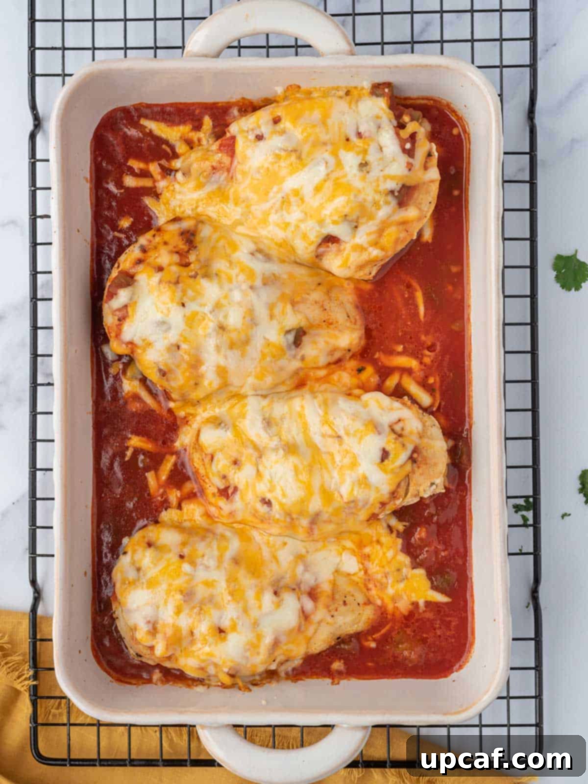 Baked salsa chicken cooling on a wire rack after being removed from the oven.