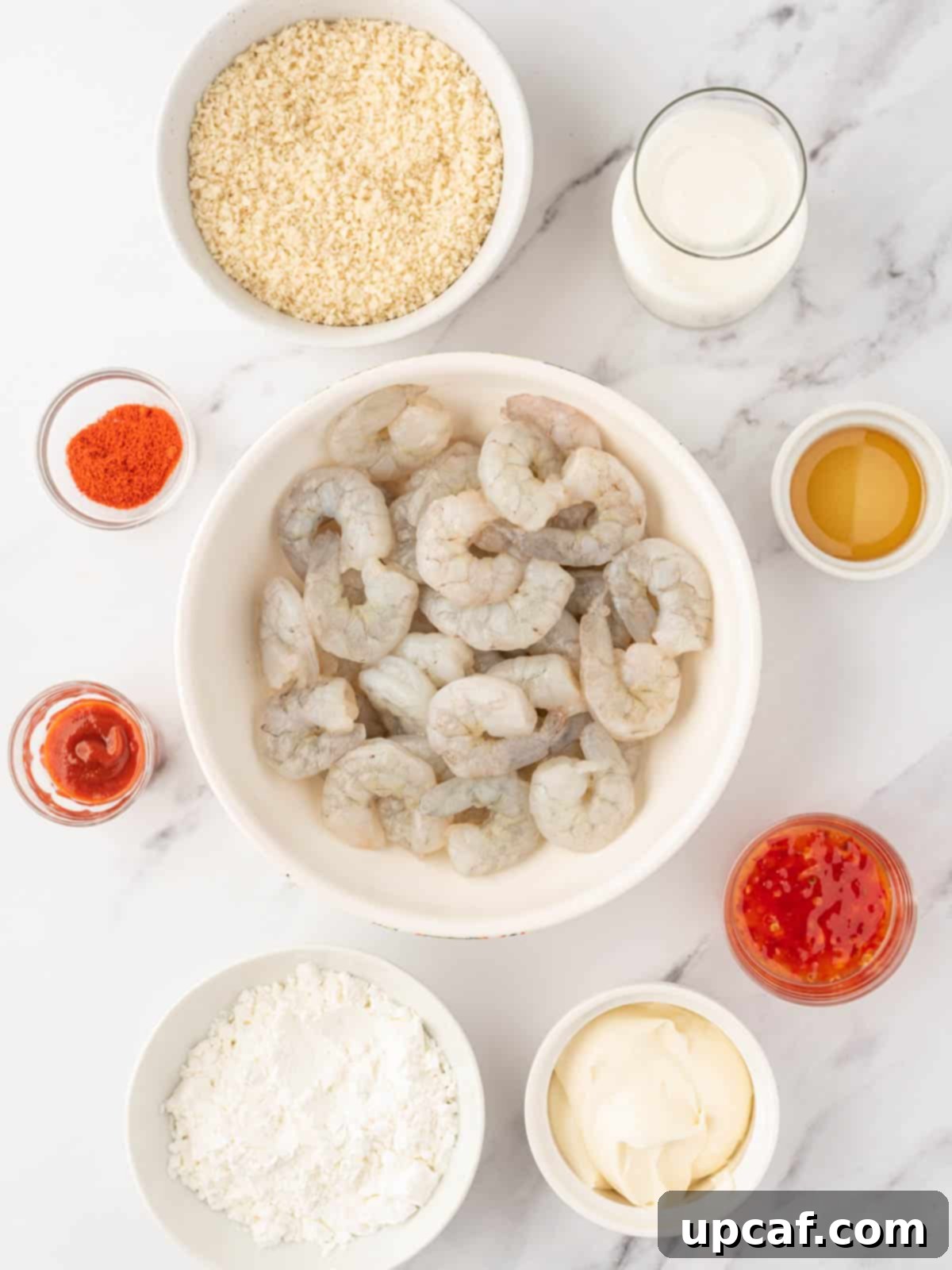 Ingredients laid out for air fryer bang bang shrimp and the creamy, spicy sauce.