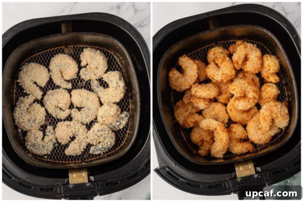 Air fryer basket loaded with panko-coated shrimp, ready for cooking.