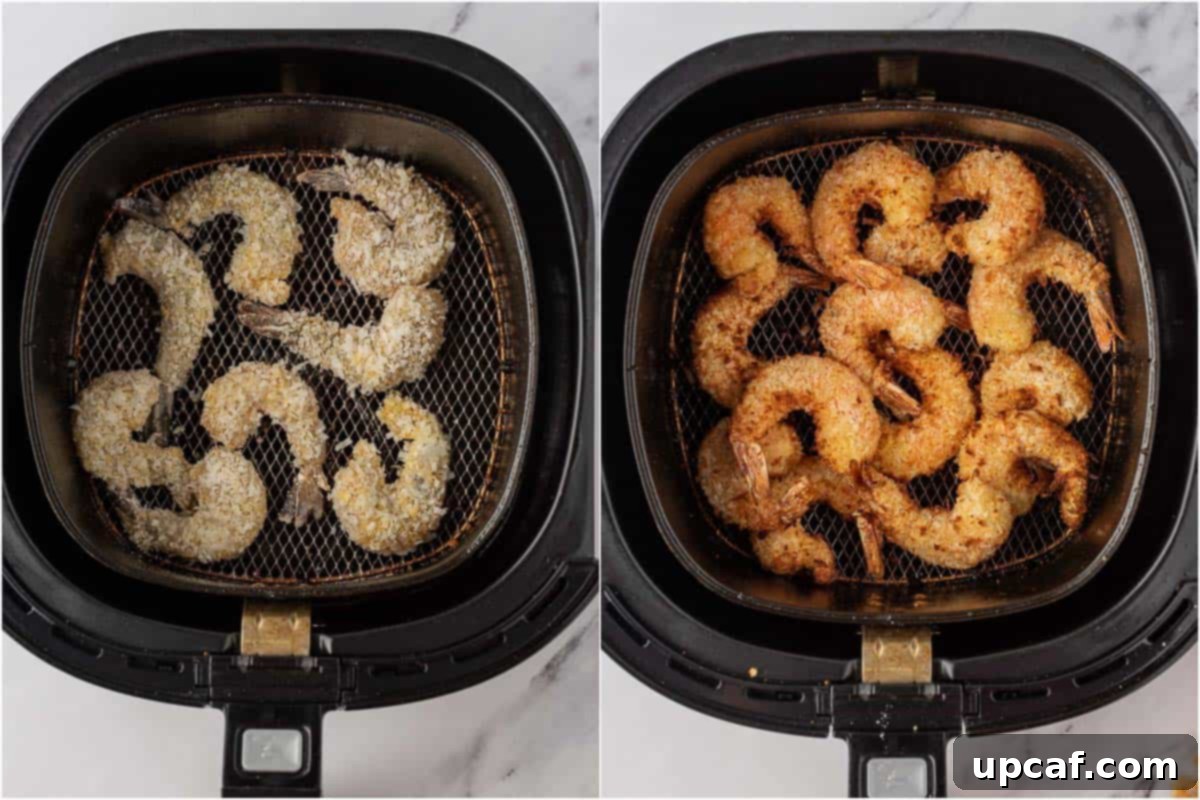 Coconut panko shrimp cooking in a single layer inside an air fryer basket, showing the process of achieving crispy air fryer shrimp.