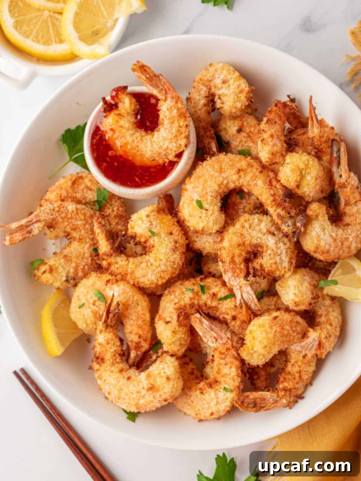 A delicious plate of crispy air fryer shrimp, perfectly golden brown and ready to be served, showcasing its enticing texture.
