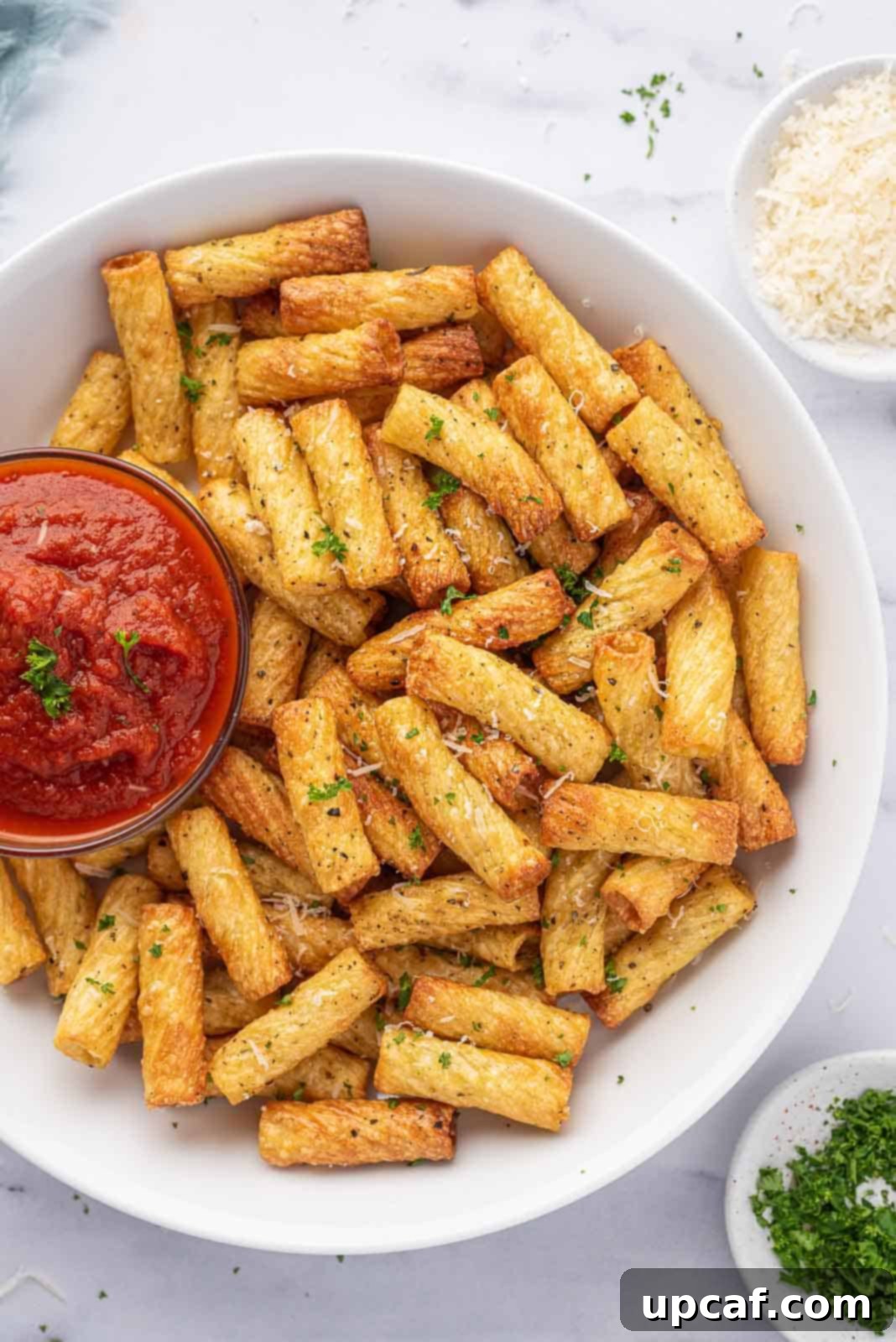 Air fryer pasta chips on a serving platter with marinara.