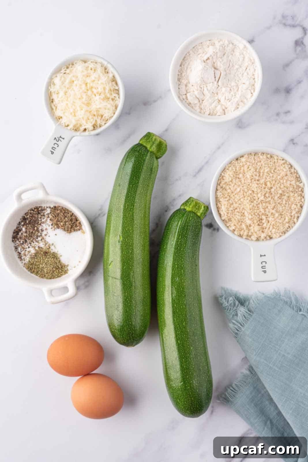 A display of all ingredients required to make crispy air fryer zucchini sticks.