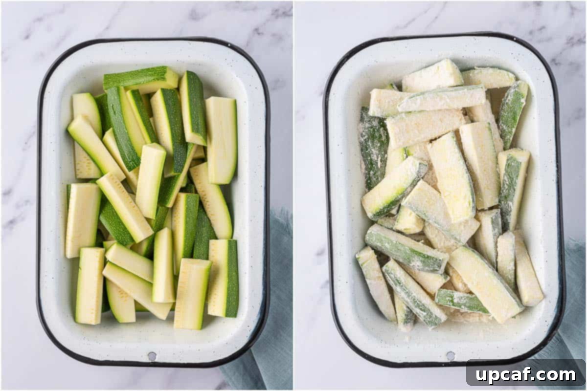 Zucchini fries being coated with flour in a shallow dish.