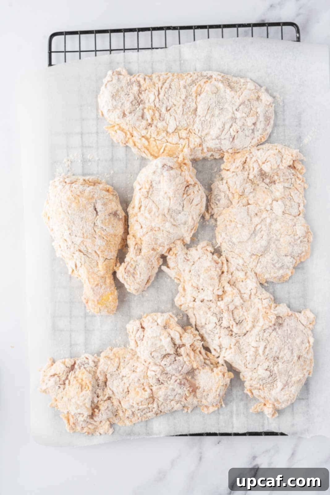 Crispy Fried Chicken Perfection 6 Dredged chicken waiting to be fried.