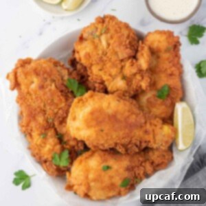 Crispy Fried Chicken Perfection 10 Extra crispy fried chicken on a serving plate.