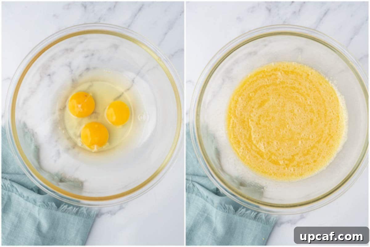 Close-up of beaten eggs, butter, almond milk, and vanilla extract forming a homogeneous mixture in a large bowl, ready for the dry ingredients.
