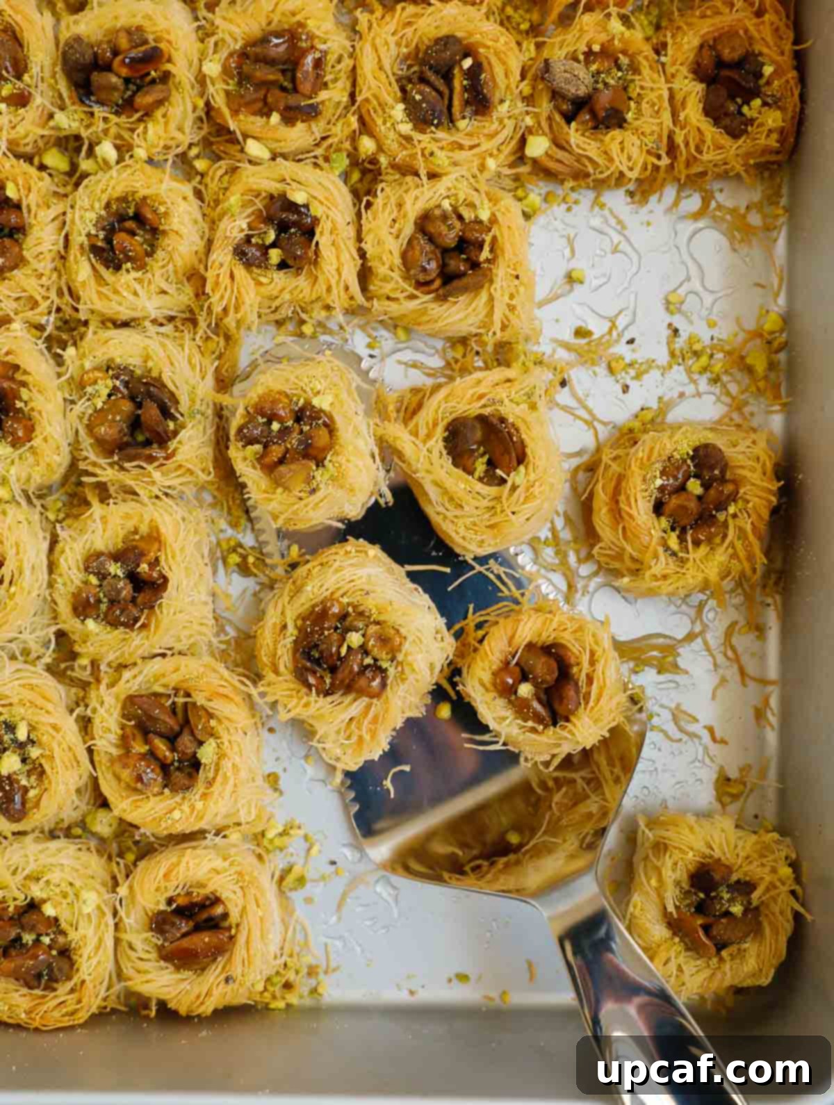 Jeweled Pistachio Nests 2 baklava bird nest after baking, golden brown and glistening with syrup