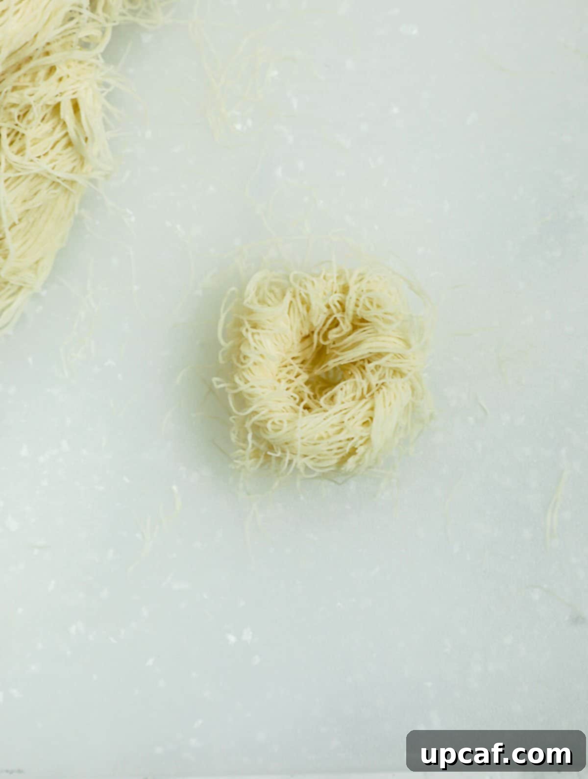 Jeweled Pistachio Nests 4 baklava phyllo nest before adding pistachios, showing the intricate coil