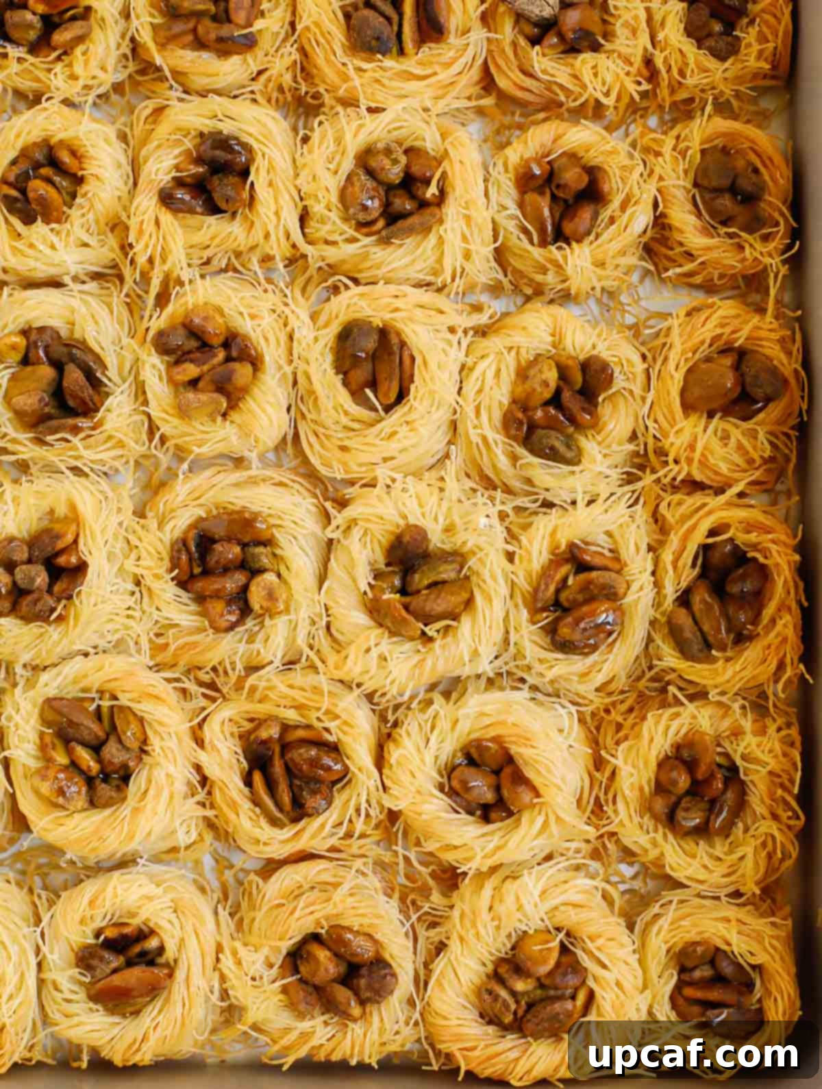 Jeweled Pistachio Nests 7 baklava bird nest after baking, soaked in simple syrup