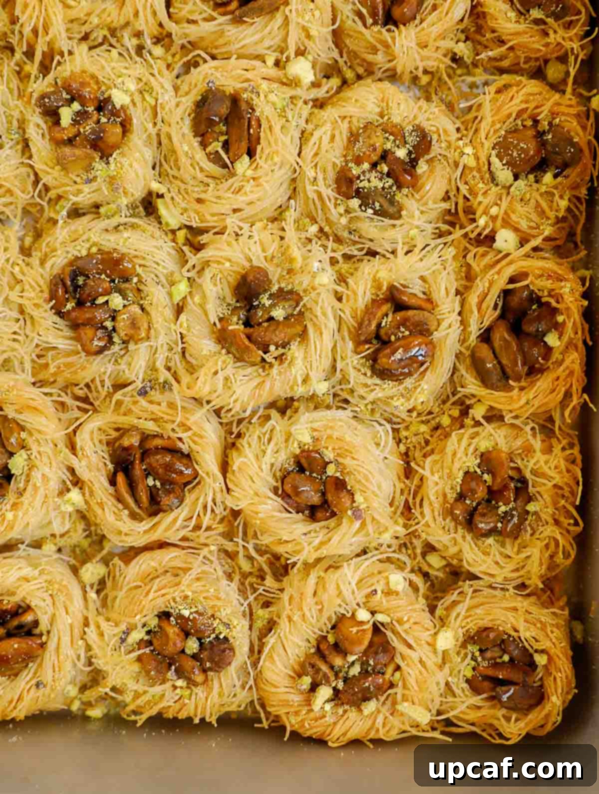 Jeweled Pistachio Nests 9 A beautiful spread of Bird Nest Baklava on a serving platter, showcasing their golden color and pistachio filling