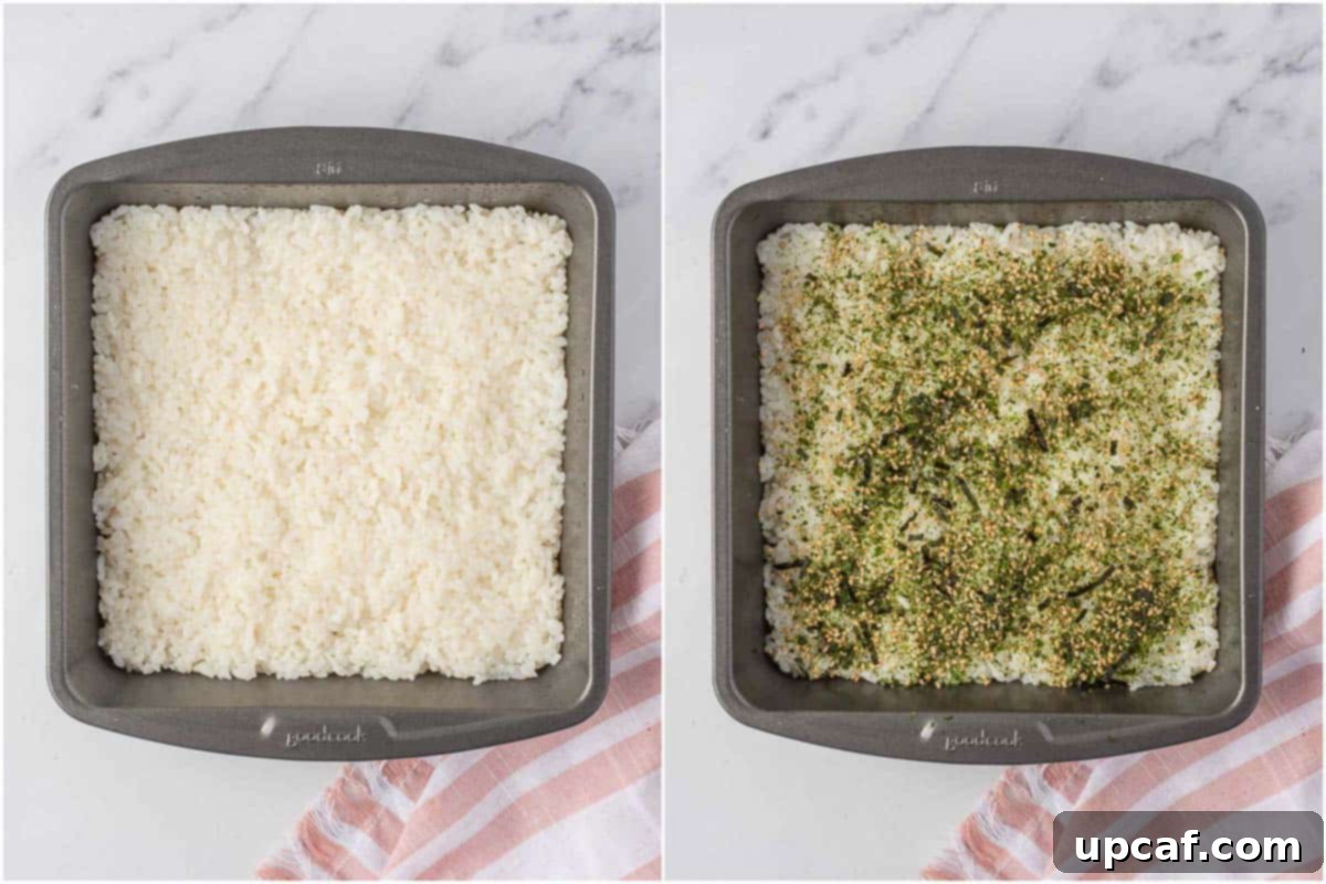 Cooked sushi rice seasoned with furikake in a square baking pan.