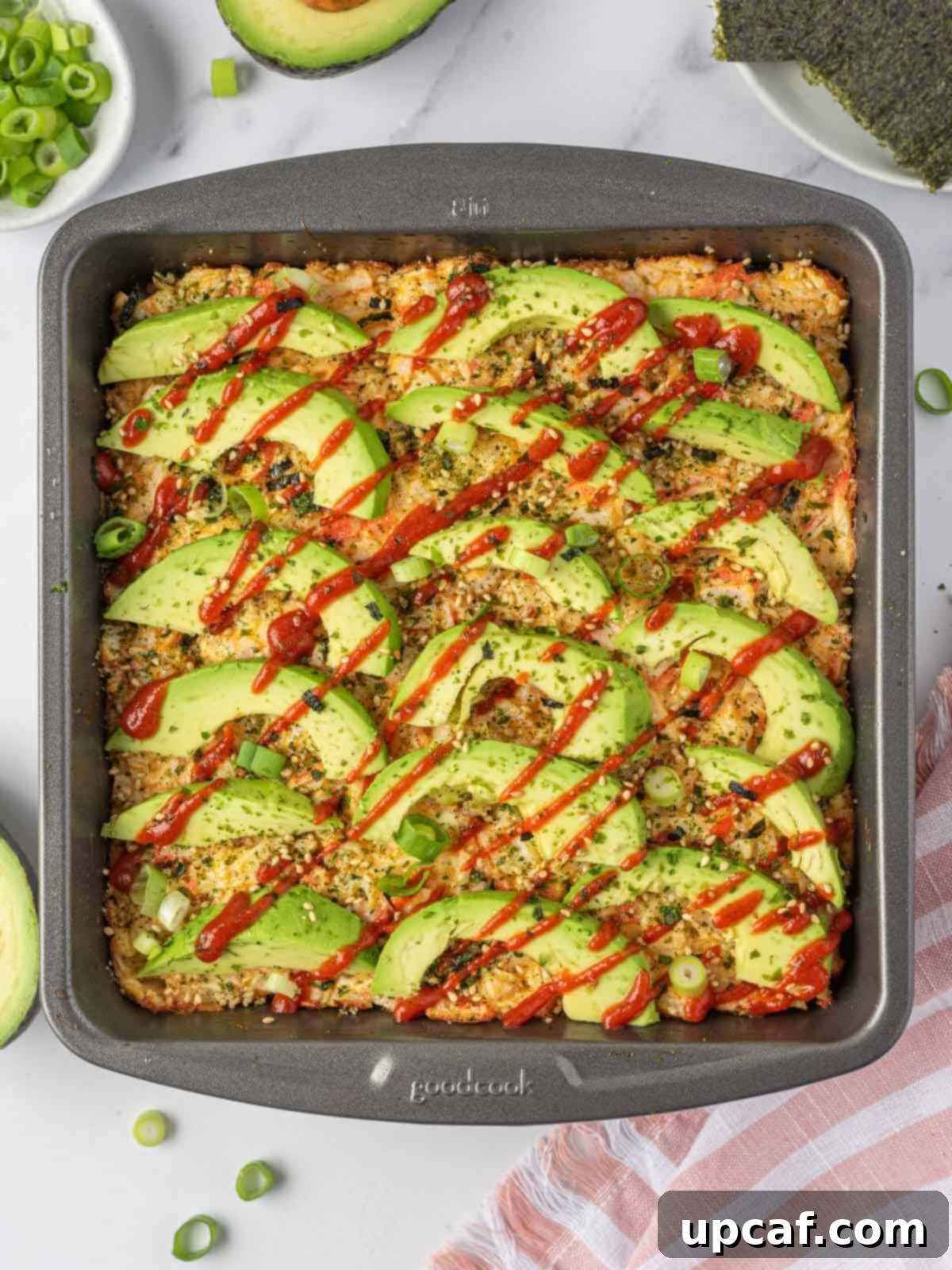 A freshly baked sushi casserole in a square pan, ready to be served.