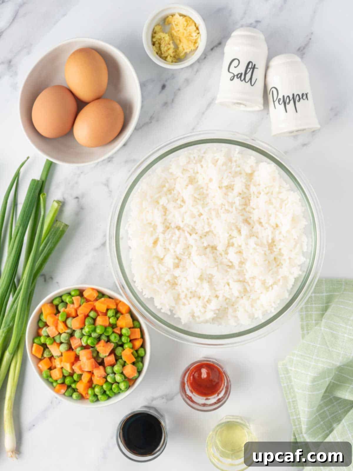Fresh ingredients laid out for making delicious vegetarian fried rice with egg.
