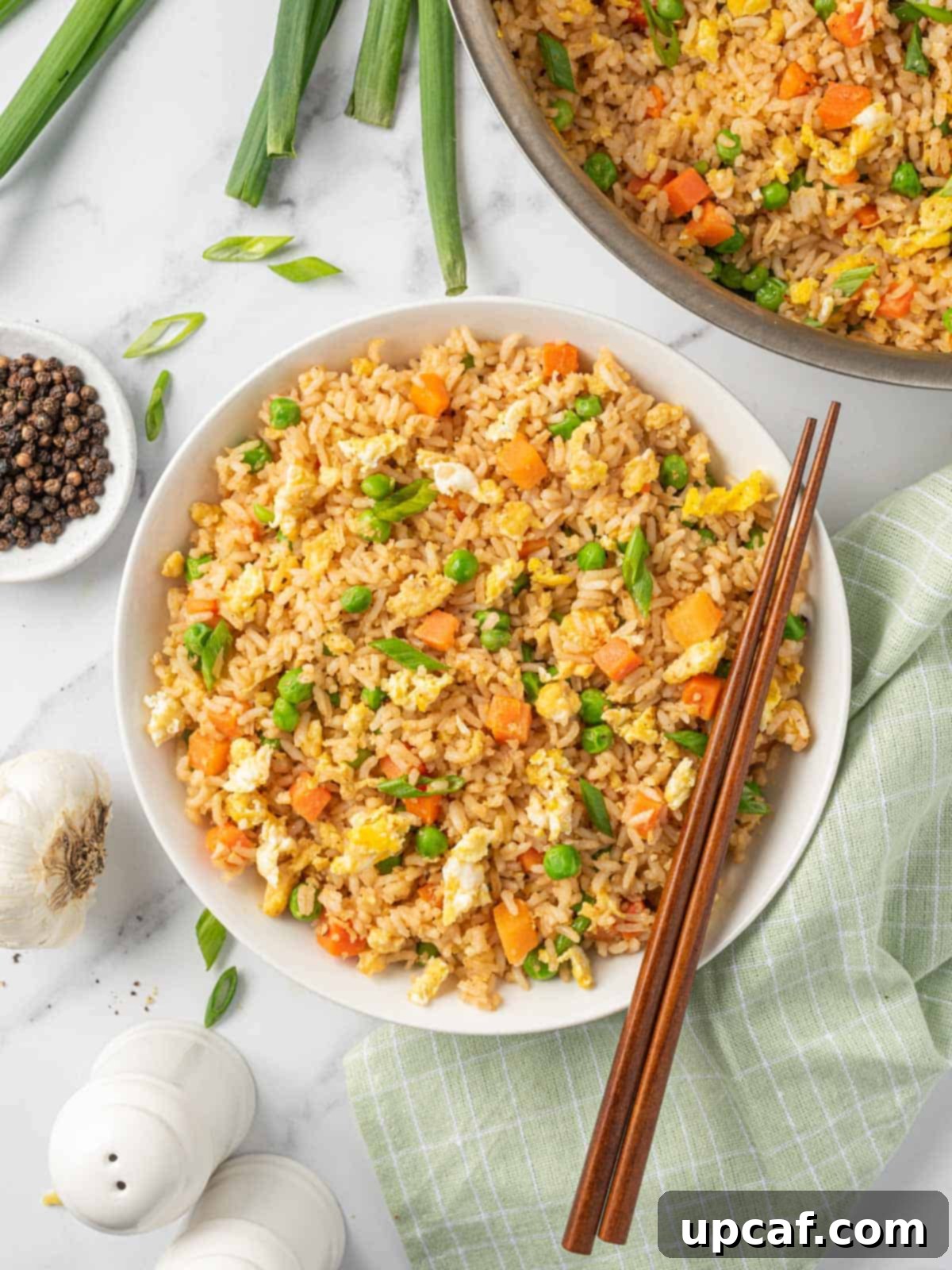 A bowl of the best Chinese fried rice, perfectly plated with chopsticks, ready for enjoyment.