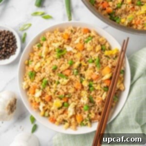 A bowl of the best Chinese fried rice with chopsticks.