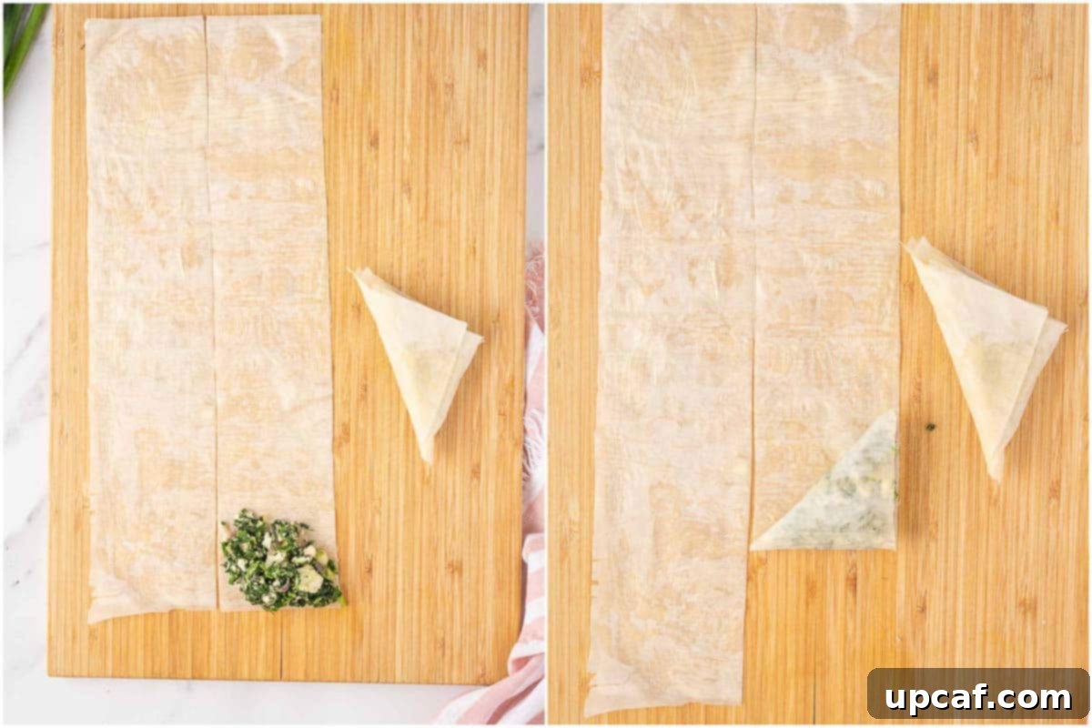 Quick & Easy Spanakopita Bites 6 Demonstration of folding a spinach and feta triangle with phyllo dough, showing the precise corner-to-corner technique.