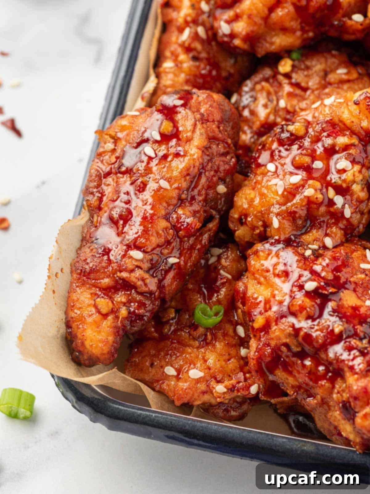 Addictive Crispy Korean Fried Chicken 12 Closeup photo of chicken coated with Gochujang korean chicken sauce.