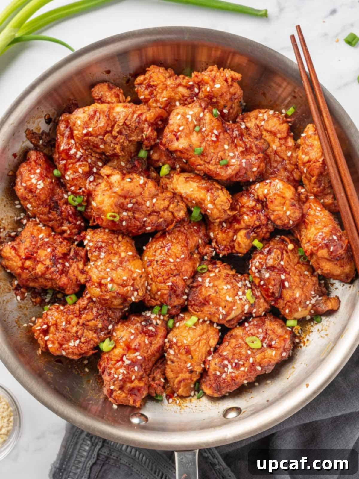 Addictive Crispy Korean Fried Chicken 10 A pot with korean crispy fried chicken and chopsticks.