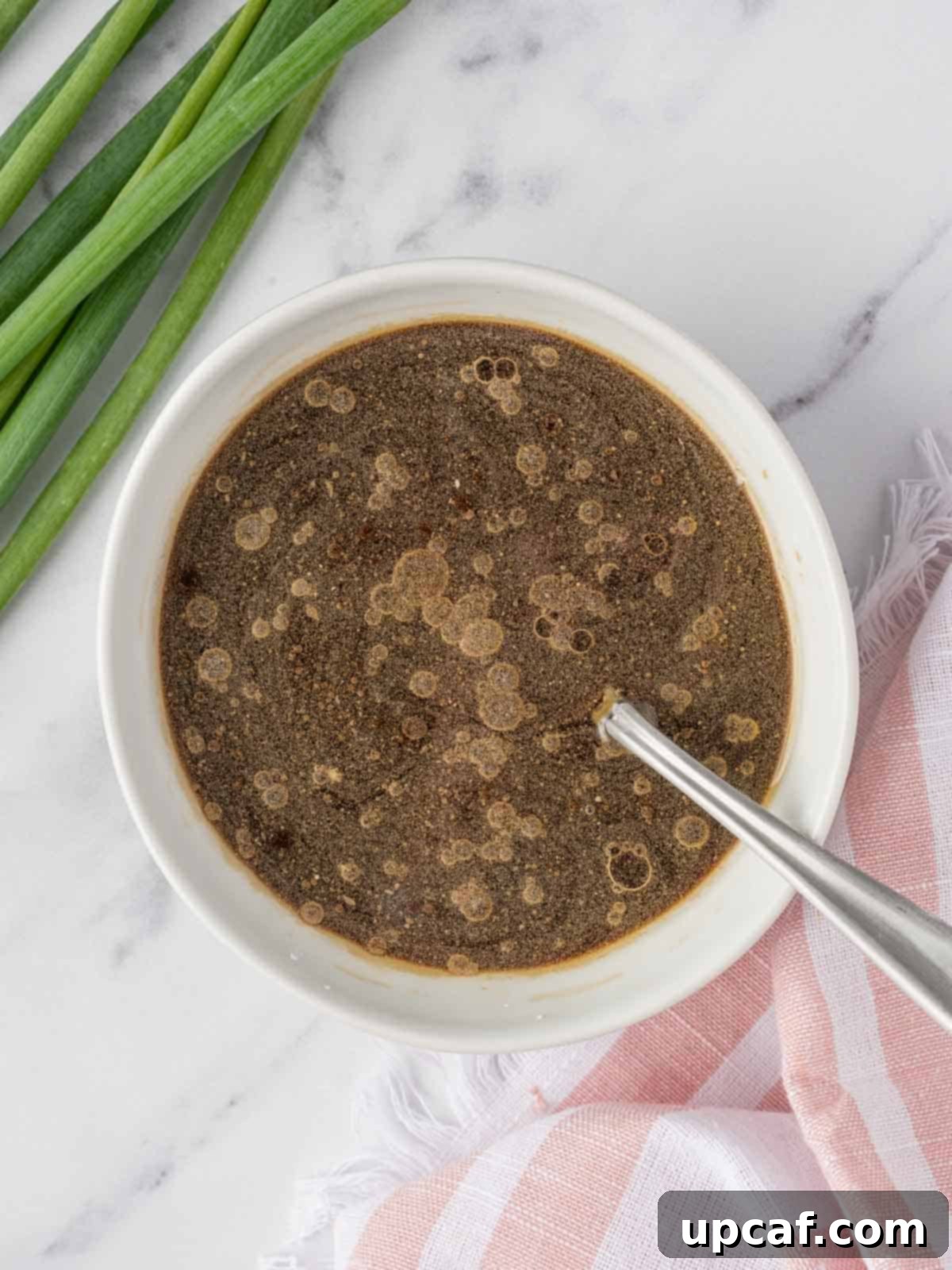 The Kung Pao sauce ingredients expertly combined in a small bowl, ready to be added to the stir fry.