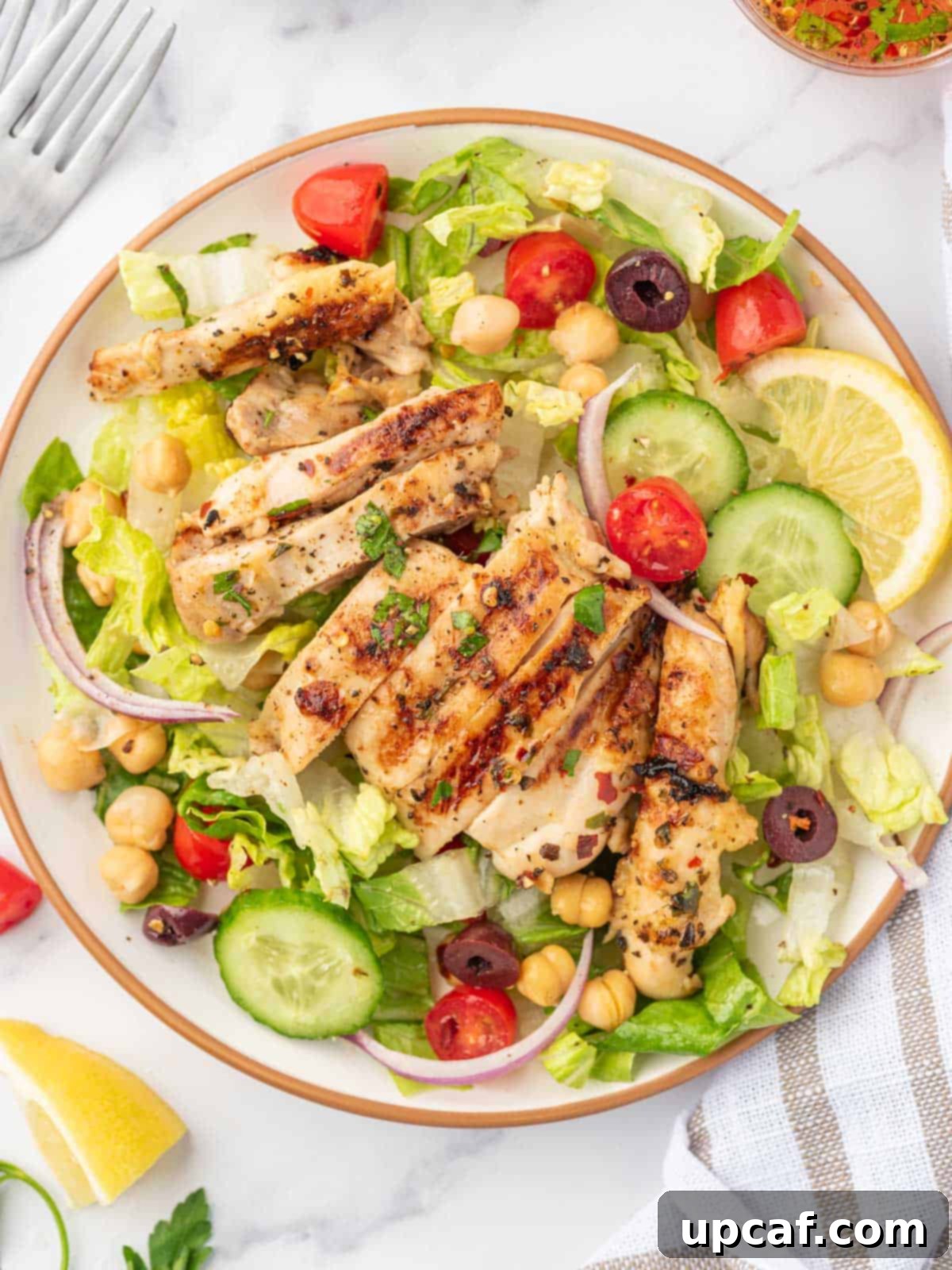 Mediterranean Grilled Chicken & Greens 9 A serving of healthy salad with chicken on a plate.