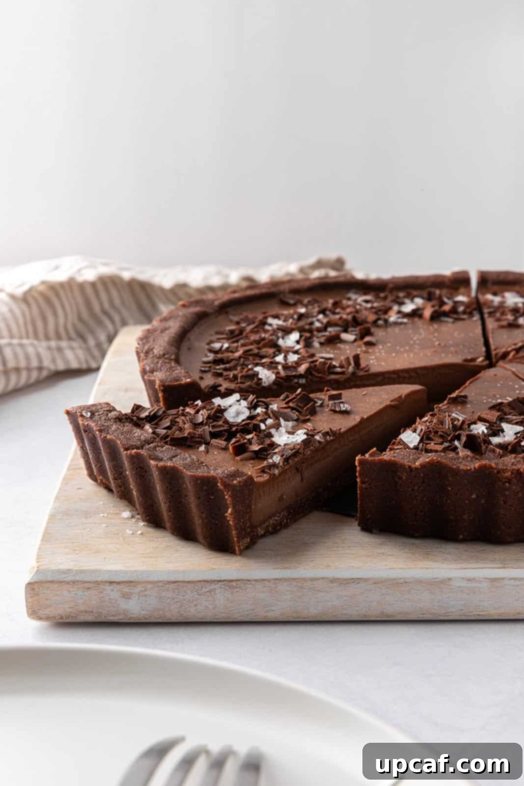 Decadent Vegan Chocolate Dream 11 Decadent vegan no bake pie is sliced on a board and ready to serve.