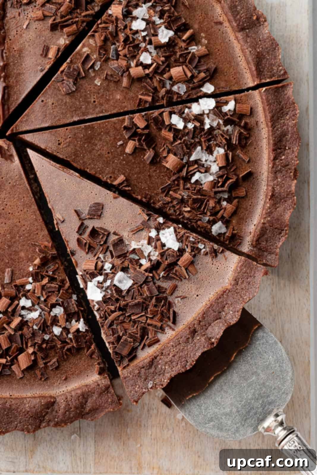 Decadent Vegan Chocolate Dream 10 A slice of the best vegan pie is being lifted on a cake serving knife.