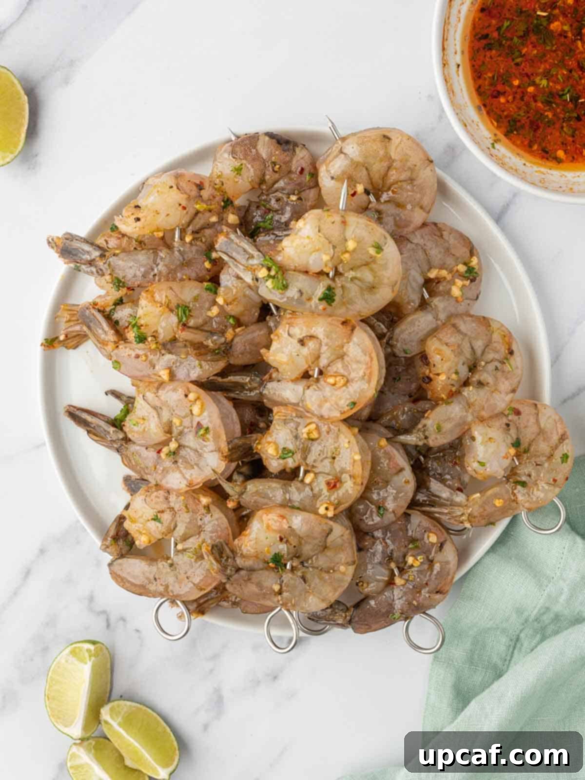 Zesty Garlic Shrimp Skewers 5 Shrimp skewers with garlic shrimp marinade ready to be grilled.