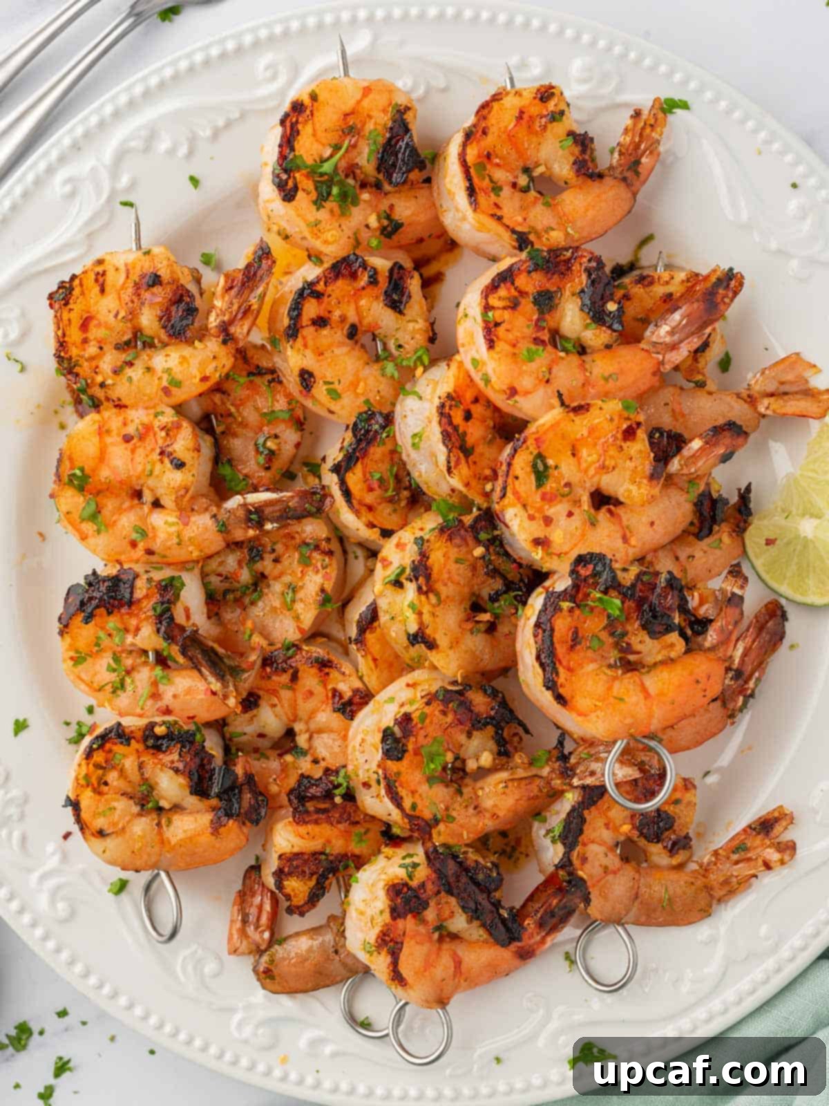 Zesty Garlic Shrimp Skewers 8 Zesty grilled garlic shrimp skewers on a platter.