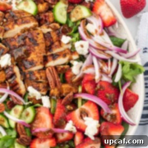 Vibrant Strawberry Grilled Chicken Salad 11 A serving platter with strawberry goat cheese salad and grilled chicken with balsamic dressing.