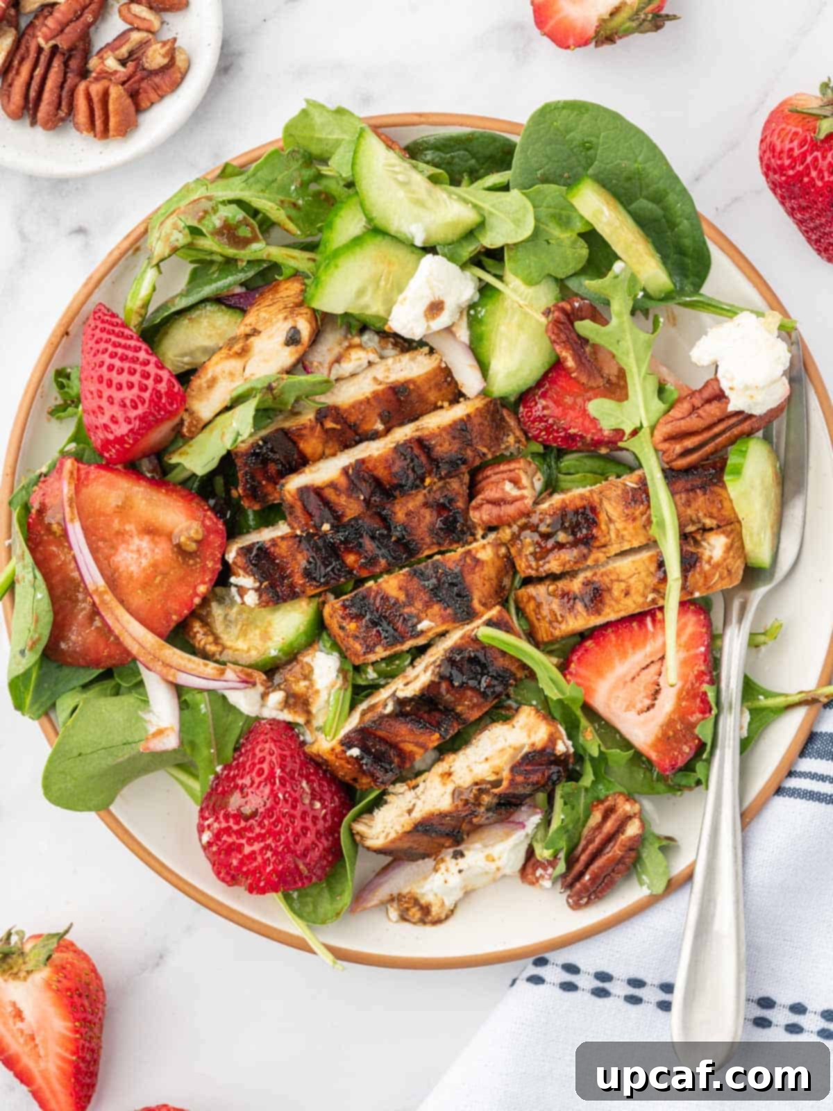 Vibrant Strawberry Grilled Chicken Salad 9 A serving plate of strawberry balsamic chicken salad with a fork.