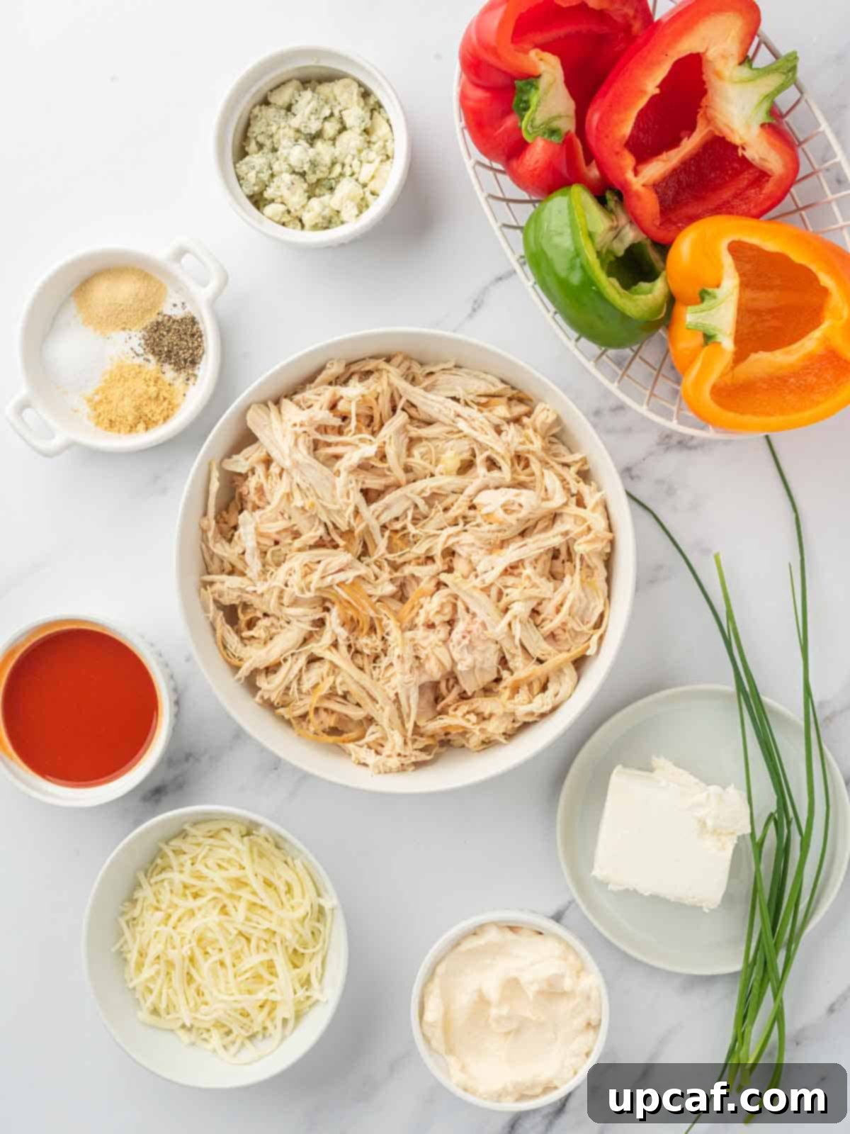 A vibrant selection of ingredients laid out, ready for making buffalo chicken stuffed peppers.