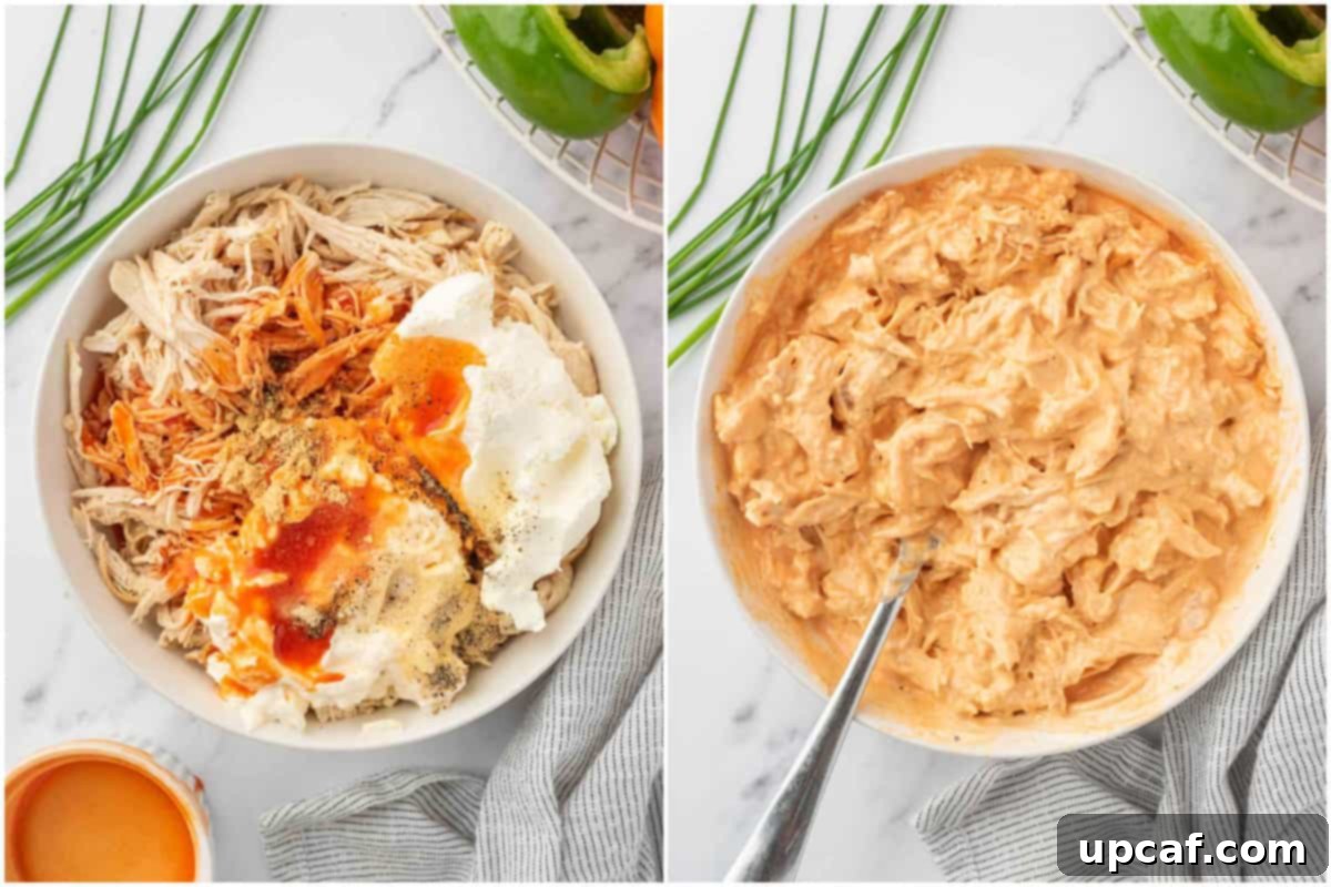 A large bowl containing all the ingredients for the buffalo chicken filling being mixed thoroughly.