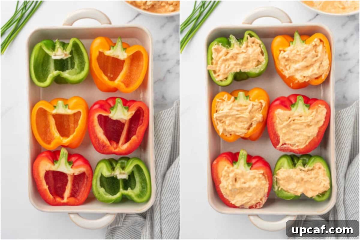 Close-up shot of bell peppers being filled with the creamy buffalo chicken mixture before baking.
