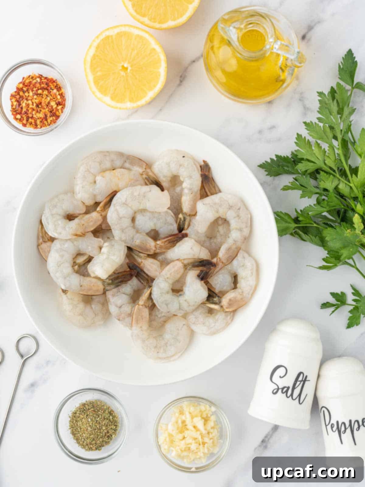 Flame-Kissed Garlic Prawns 3 Ingredients needed for grilled garlic shrimp skewers laid out on a table.