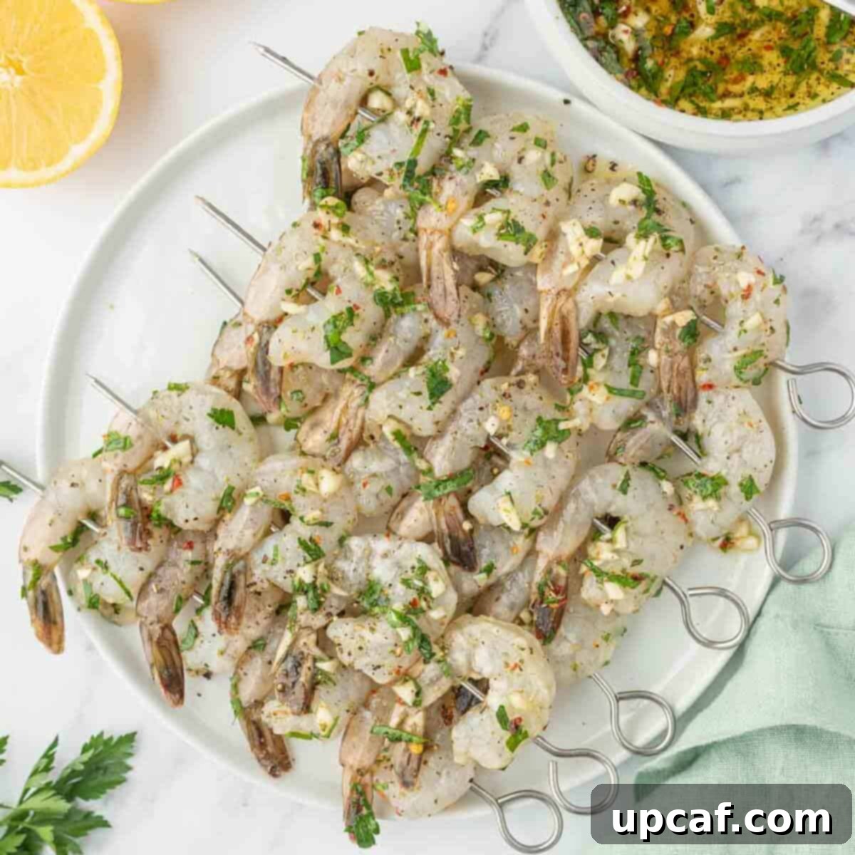 Flame-Kissed Garlic Prawns 6 Shrimp skewers coated in a garlic citrus marinade, ready for grilling.