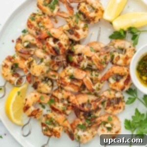 Flame-Kissed Garlic Prawns 9 Garlicky Shrimp kabobs on a platter.