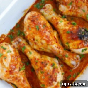 Chicken legs with honey mustard in a baking dish for serving.