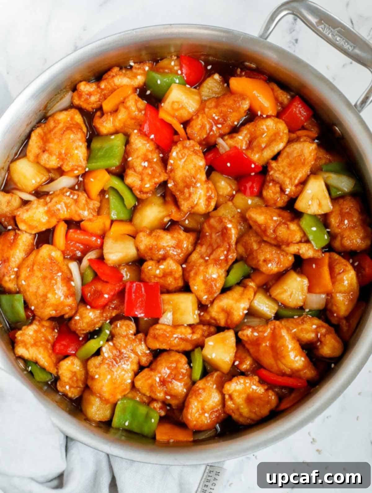 Crafting Delicious Sweet and Sour Chicken at Home 2 Homemade sweet and sour chicken in a skillet.