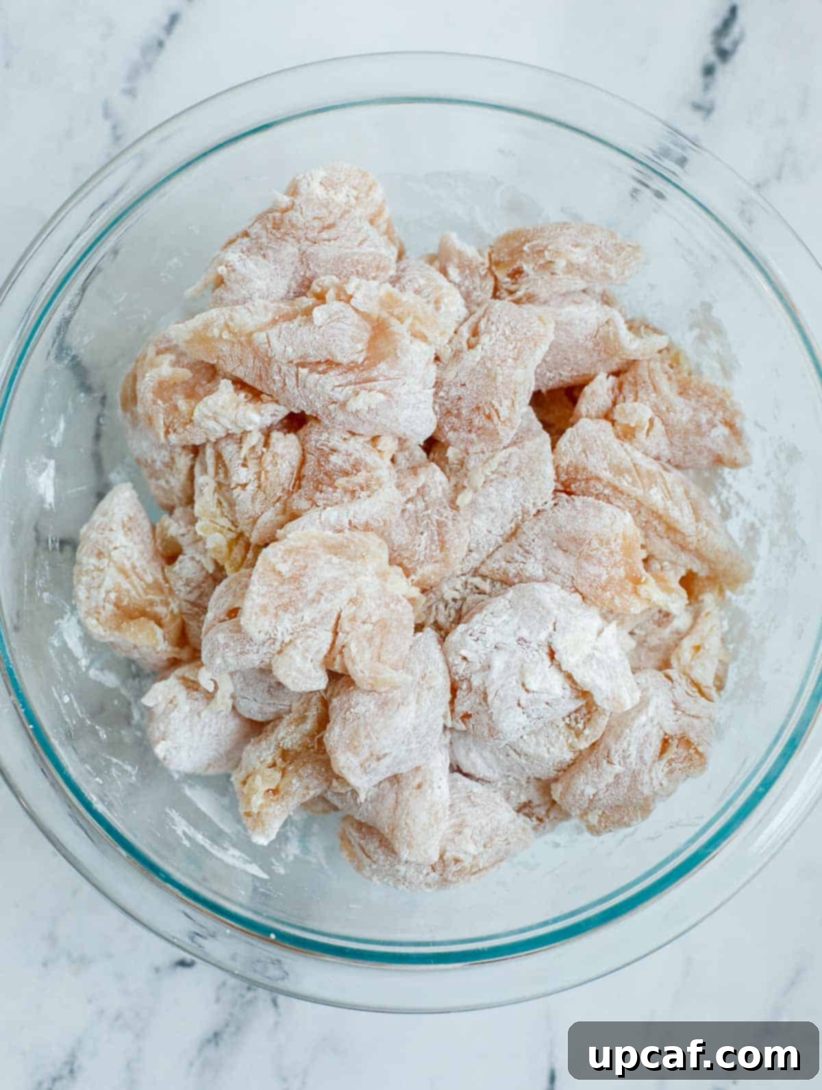 Crafting Delicious Sweet and Sour Chicken at Home 5 Breading chicken before frying.