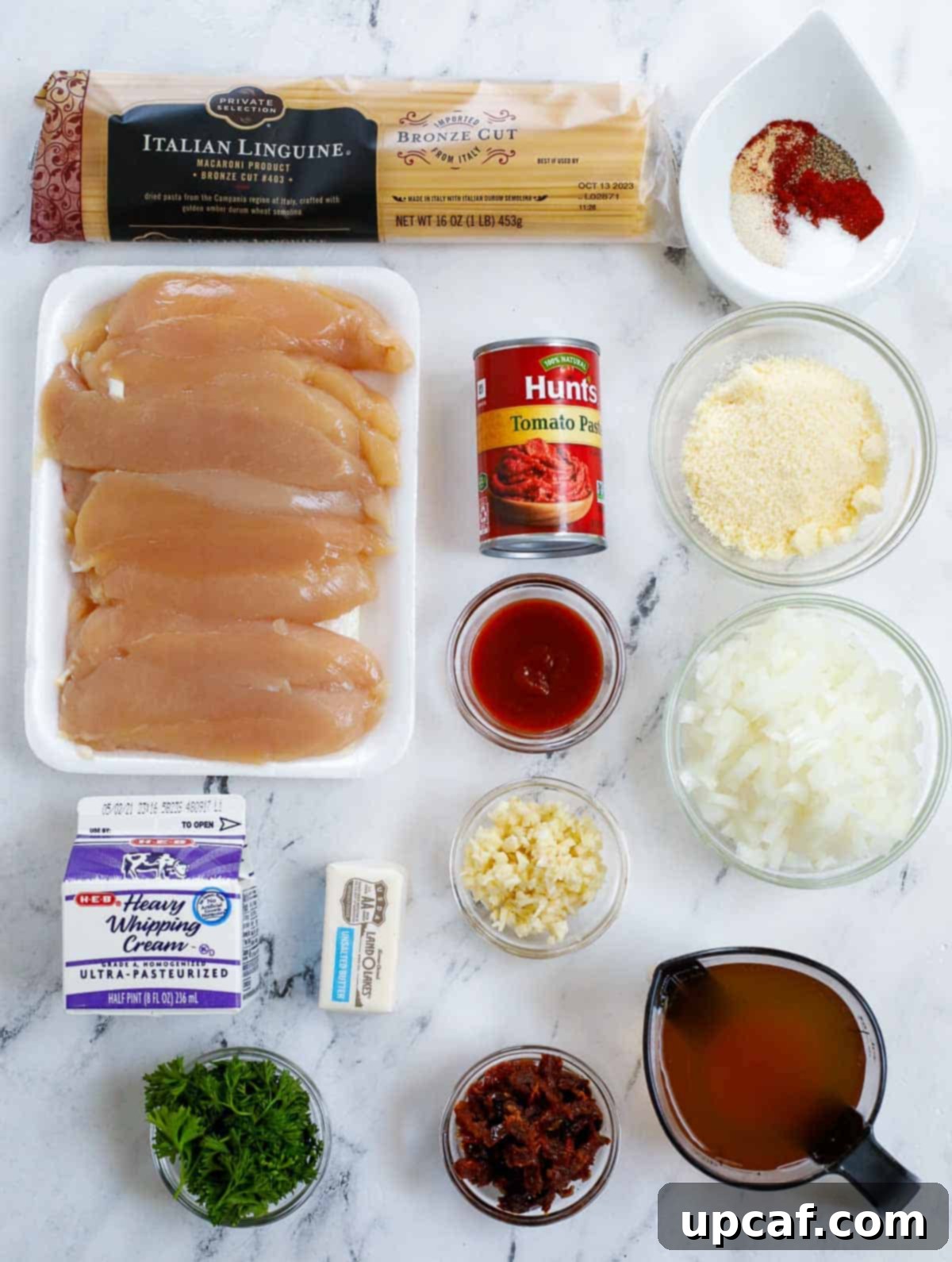 Ingredients needed for creamy spicy chicken pasta laid out on a table.