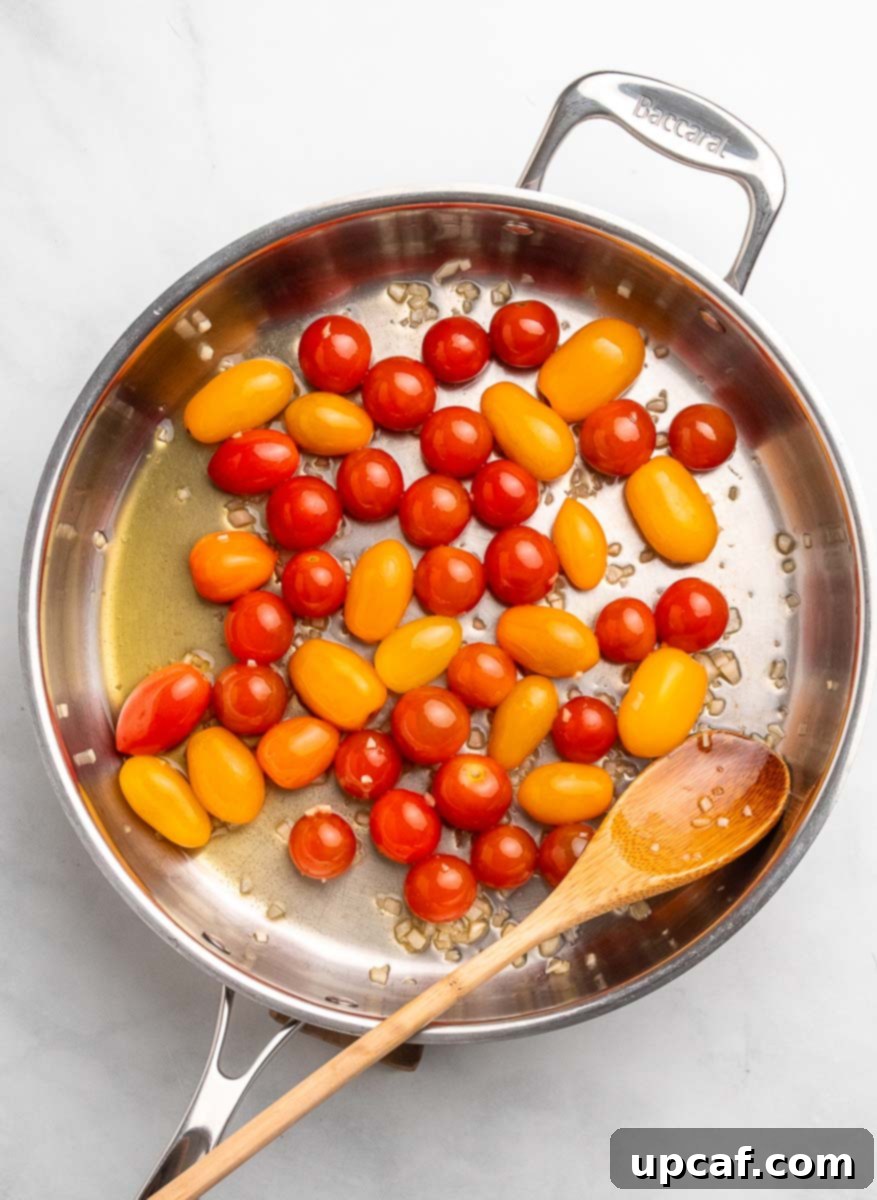 Bursting Cherry Tomato Pesto Pasta 4 cherry tomatoes in a skillet