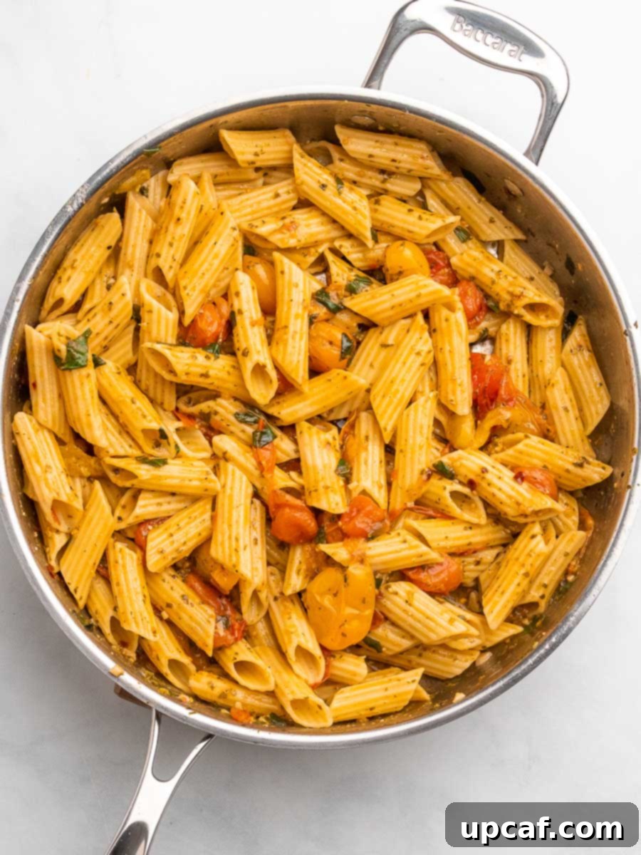 Bursting Cherry Tomato Pesto Pasta 9 cherry tomato pesto pasta in a skillet